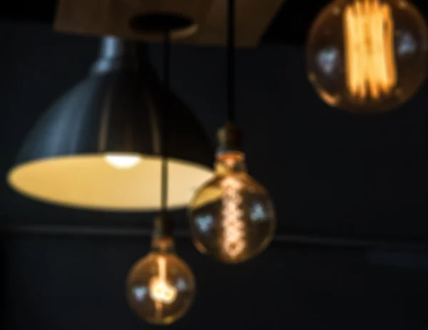 Blur of hanged lamps in dark room — Stock Photo, Image