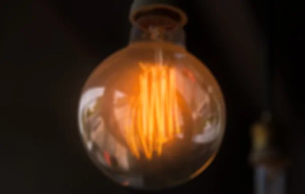 Blur of orange lamp in dark room — Stock Photo, Image