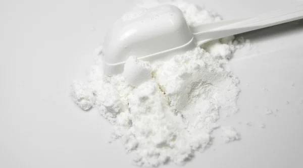 Scoop of White Collagen amino protein powder  poured with spoon — Stock Photo, Image