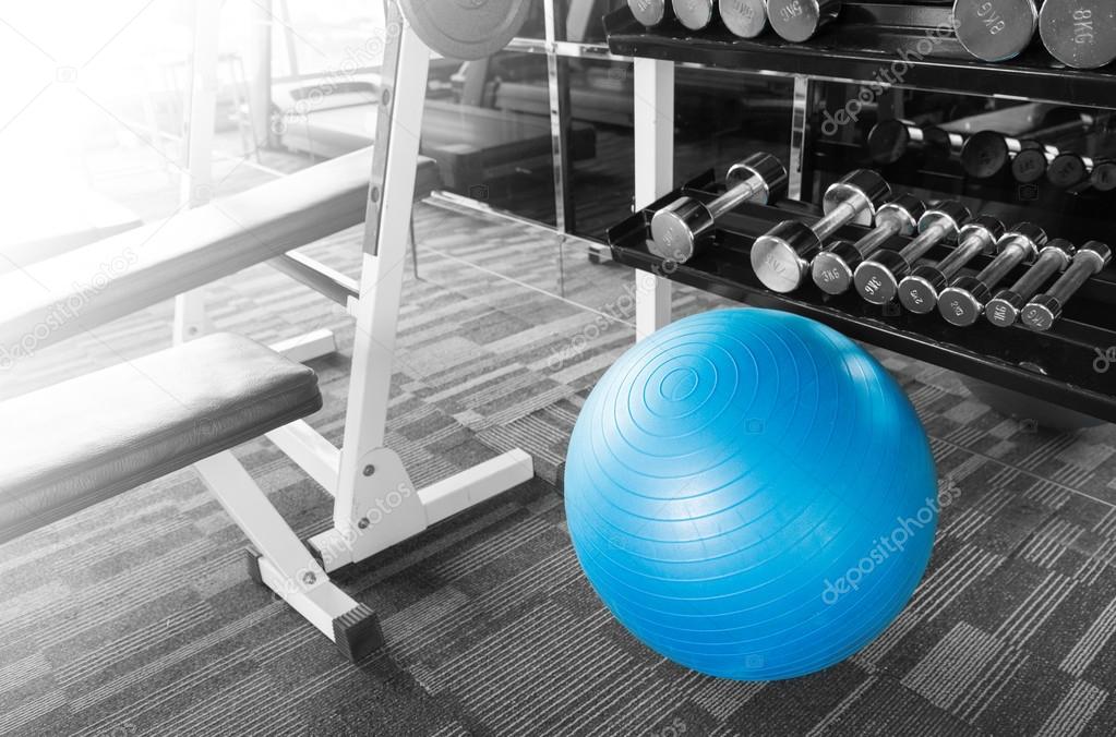 Fitness gym with ball, dumbell and other equipment with shining 