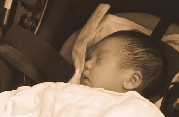 Asian Thai baby sleeping on stroller sepia — Stock Photo, Image