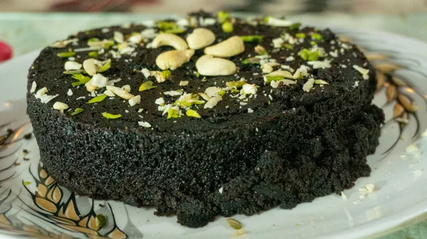 Biscuit cake with dry fruit filling decorated with cashew pistachios making at home made
