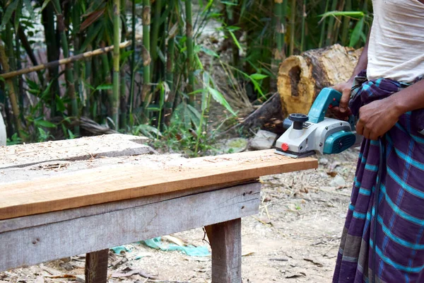 Man planed board Electrical plane. Construction, wood processing