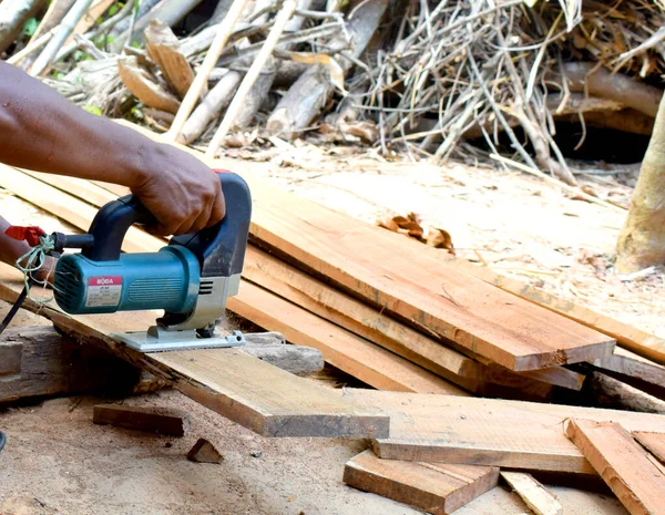 Man planed board Electrical plane. Construction, wood processing