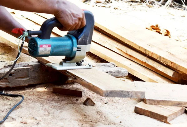 Man planed board Electrical plane. Construction, wood processing