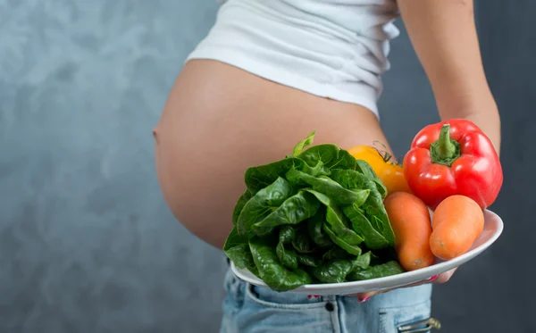 Close up of a cute pregnant belly tummy and healthy food. Pregna — Stok fotoğraf