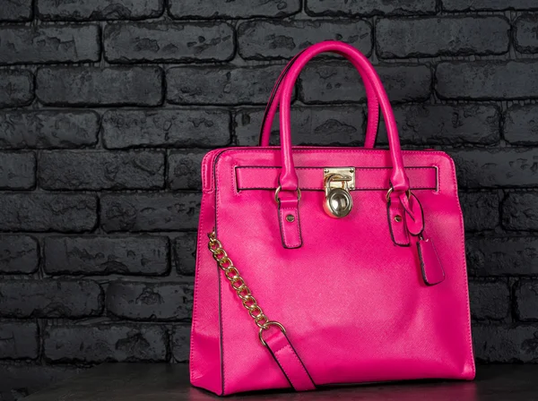 Pink stylish female leather bag isolated on dark background — Stock Photo, Image