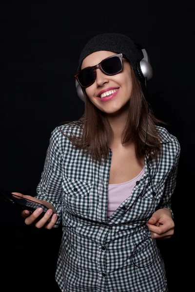 stock image happy listening music with big headphones  phone or player