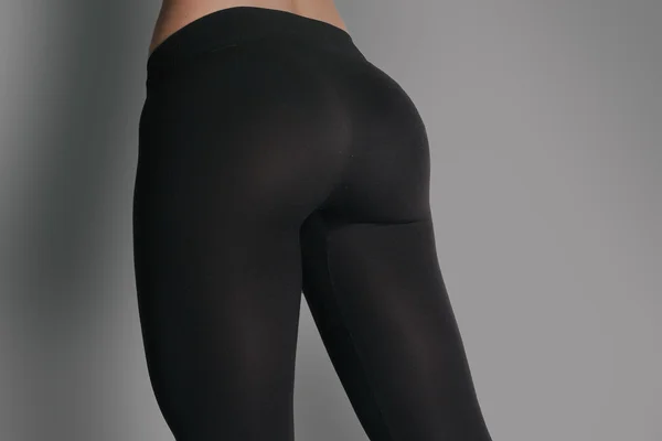 Woman in leggings and sneakers, low section. athletic ass Stock Picture
