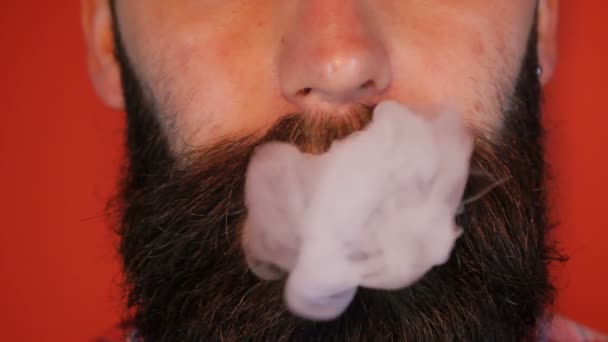 Uomo con la barba che fuma una sigaretta elettronica — Video Stock