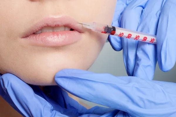 Attractive young woman gets cosmetic injection — Stock Photo, Image