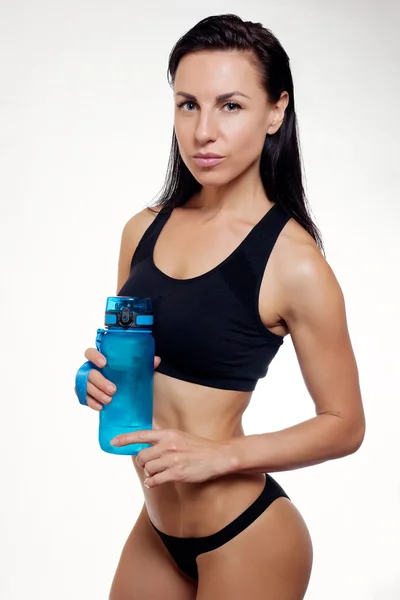 Front view of slim fitness woman drinking water. — Stock Photo, Image