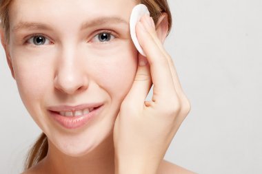 mutlu kadın yüzünü pamuklu ped ile Temizleme