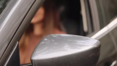 driving, safety and people concept - Young woman in car. Auto as present or gift at birthday. Happy girl in a city with her new automobile holding keys. 4k