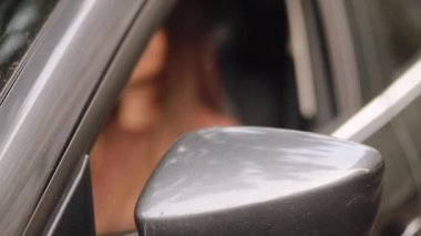 driving, safety and people concept - Young woman in car. Auto as present or gift at birthday. Happy girl in a city with her new automobile holding keys. 4k