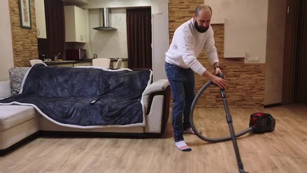 Funny Young Man Listening Music Headphone While Cleaning Floor Vacuum — Stock Video