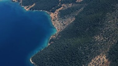 Clouds,view from airplane window, view of fields and meadows. view of the bay with turquoise water. mountain and quarry views