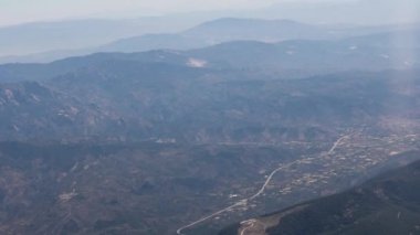 Clouds,view from airplane window, view of fields and meadows. view of the bay with turquoise water. mountain and quarry views