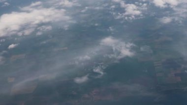 Clouds,view from airplane window, view of fields and meadows. view of the bay with turquoise water. mountain and quarry views