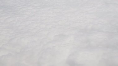 Clouds,view from airplane window, view of fields and meadows. view of the bay with turquoise water. mountain and quarry views