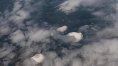 Clouds,view from airplane window, view of fields and meadows. view of the bay with turquoise water. mountain and quarry views