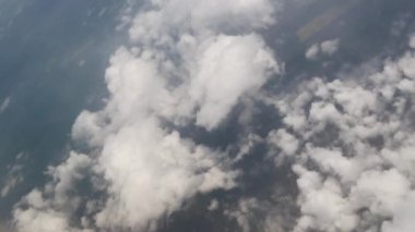Clouds,view from airplane window, view of fields and meadows. view of the bay with turquoise water. mountain and quarry views
