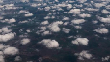 Clouds,view from airplane window, view of fields and meadows. view of the bay with turquoise water. mountain and quarry views
