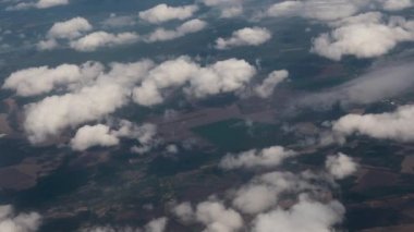 Clouds,view from airplane window, view of fields and meadows. view of the bay with turquoise water. mountain and quarry views