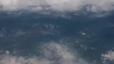 Clouds,view from airplane window, view of fields and meadows. view of the bay with turquoise water. mountain and quarry views