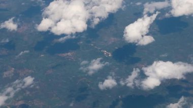 Clouds,view from airplane window, view of fields and meadows. view of the bay with turquoise water. mountain and quarry views