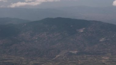 Clouds,view from airplane window, view of fields and meadows. view of the bay with turquoise water. mountain and quarry views