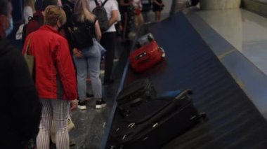 People wait luggage near tape in hall of airport, airport - dynamic complex, serving about 170 thousand tourists annually.