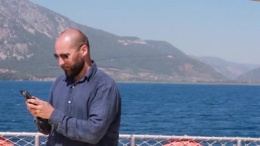 Dağlar ve turkuaz sularla bir deniz yatında yüzen Kafkasyalı bir gezgin. Sosyal ağlarda yeniden yazılar yüzme, güneşlenme gezgin şehvet konsepti sahnesi.
