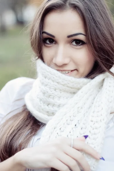 Sad, dark-haired woman wrapped in a scarf — Stock Photo, Image