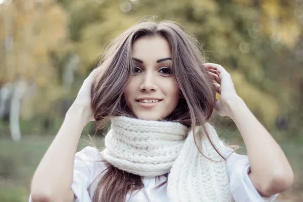 Sad, dark-haired woman wrapped in a scarf — Stock Photo, Image