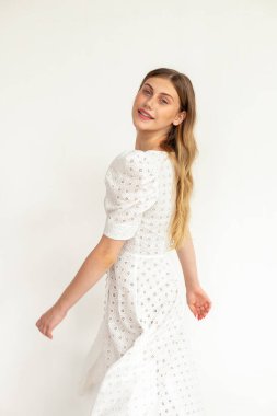 Motion with dress motion, bright studio background, summer fashion editorial.