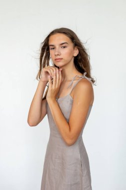 Minimal portrait with hands near face, soft emotional mood, modern editorial style.