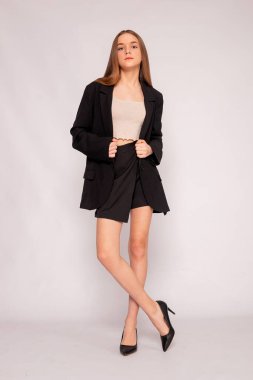 Tam boy portre, siyah ceket, beyaz arka planda kendine güvenen iş modası..