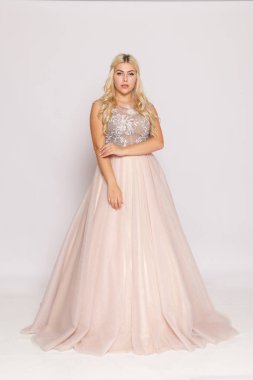 Tam boy stüdyo resmi, allık tüllü elbise giymiş sarışın kadın resmi, resmi etkinlik tarzı, temiz bir arka plan..