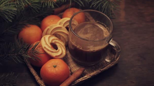 Tangerines and cinnamon stick, lit sparkler on vintage wooden background — Stock Video