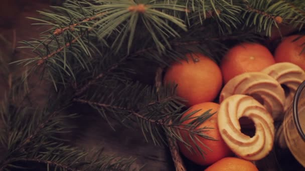 Tangerines and cinnamon stick, lit sparkler on vintage wooden background — Stock Video