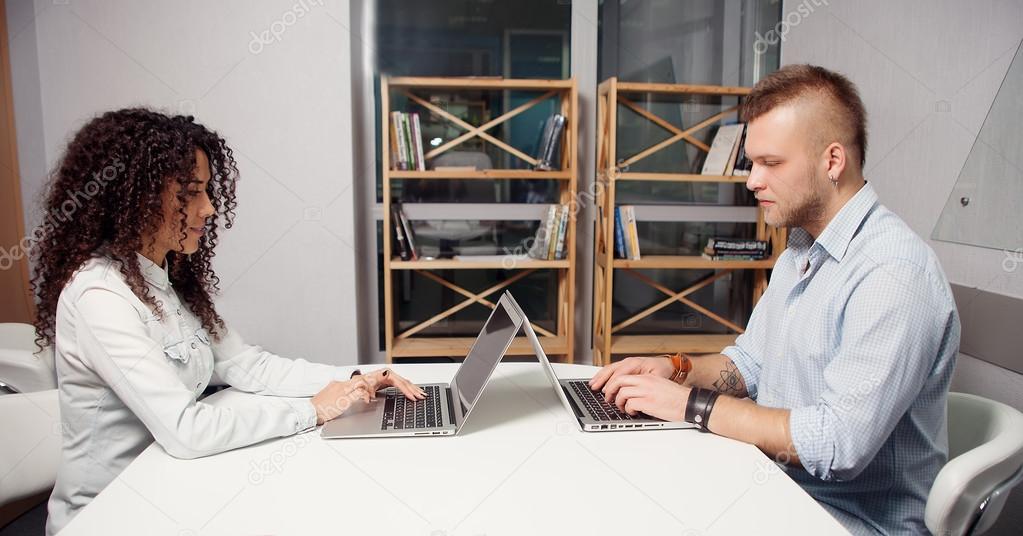 major partners working at desk using laptop in the office