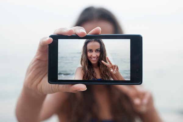 Portrait of attractive teenager girl standing summer sandy beach holiday