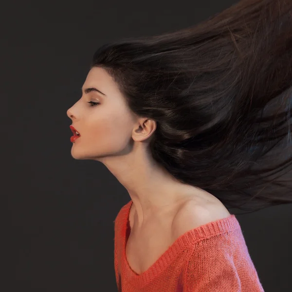 young brunette woman head-shoulders studio shot