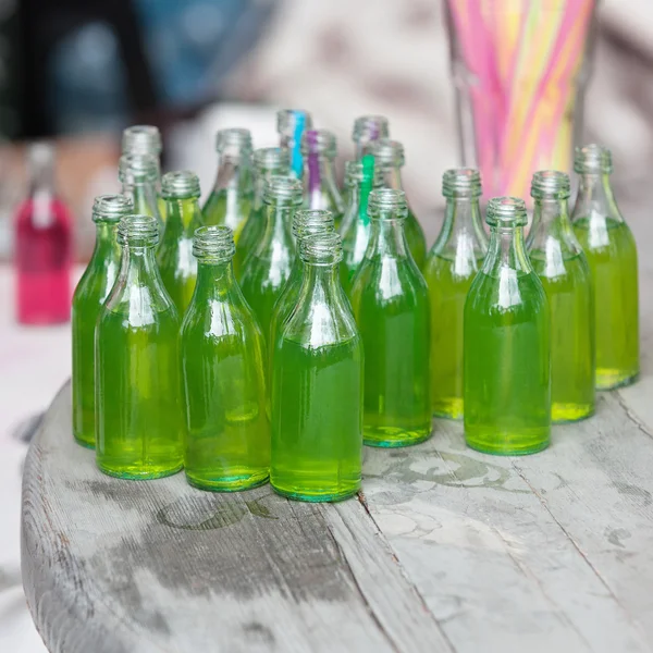 Vivid drink in glass bottles — Stock Photo, Image