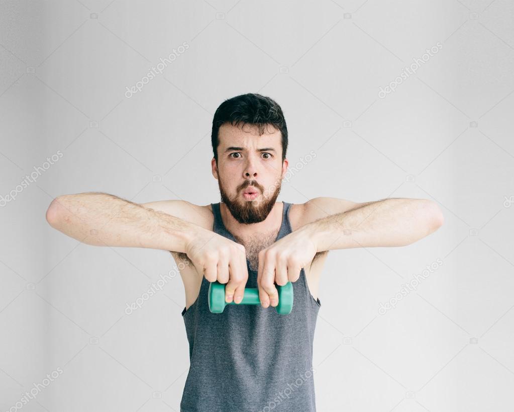 Skinny man training his bicep — Stock Photo © Estradaanton