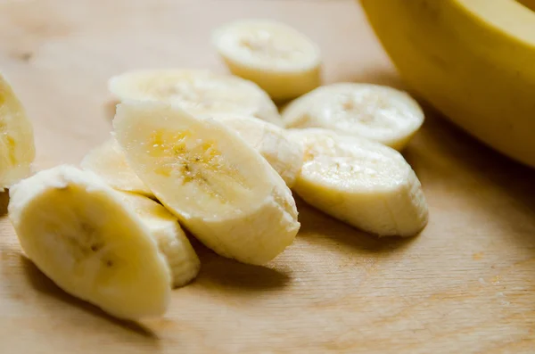 piece of peeled banana sliced on cutting board