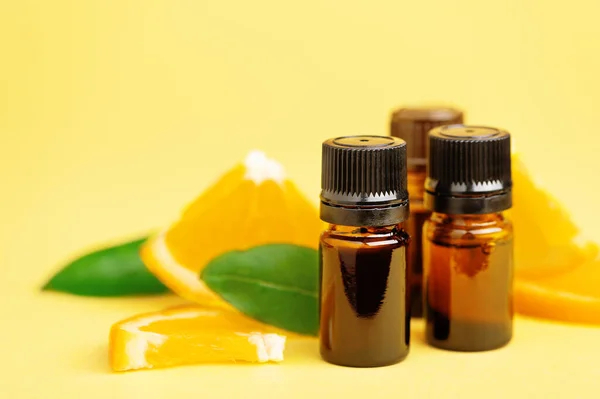 Bottles Citrus Essential Oil Slices Orange Composition Yellow Background Useful — Stock Photo, Image