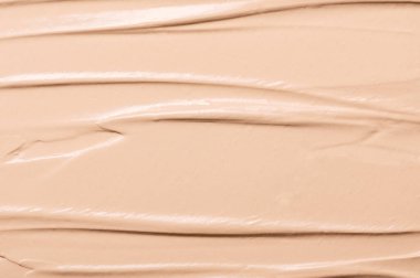 Bej sıvısı kremalı fondöten dokusu yakın plan. Nemlendirici çırılçıplak BB kremi. Doğal mineral kozmetik, profesyonel makyaj için güzellik ürünü. Kapatıcı, fosforlu kalem, mükemmel cilt.