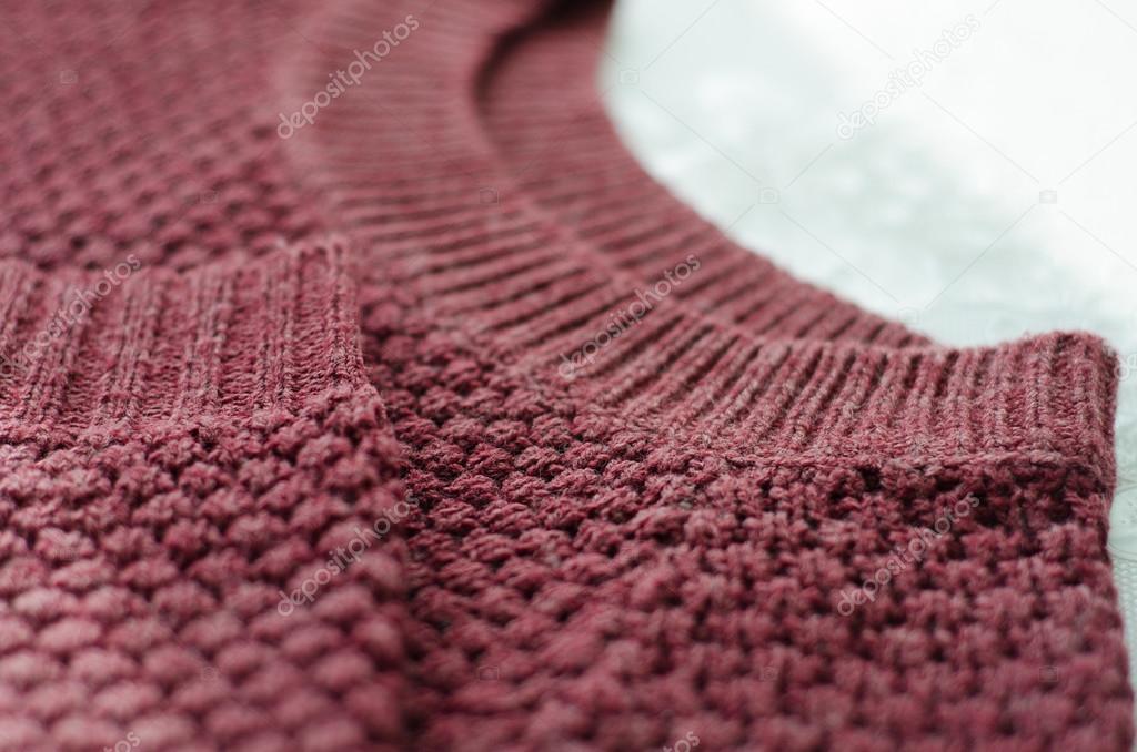 knitted burgundy sweater on white background